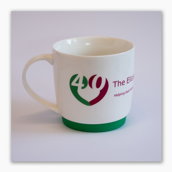 White porcelain mug with detachable green silicon base, specially made to celebrate The Elizabeth Foundation's 40th anniversary