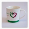 White porcelain mug with detachable green silicon base, specially made to celebrate The Elizabeth Foundation's 40th anniversary