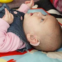 Baby with a hearing aid at The Elizabeth Foundation